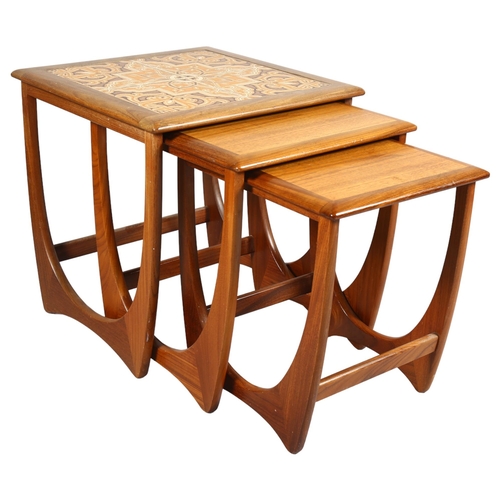 553 - A 1970's G-Plan nest of 3 tables, afromosia and teak construction with tile top to the largest table... 