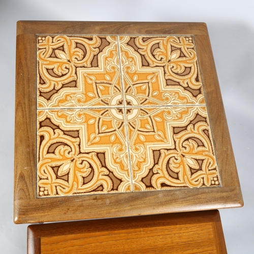 553 - A 1970's G-Plan nest of 3 tables, afromosia and teak construction with tile top to the largest table... 