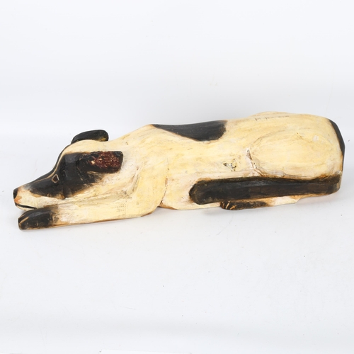 563 - Gerard Rigot (b.1929), France, a wood carved and painted crouching dog, signed to base, length, 51cm