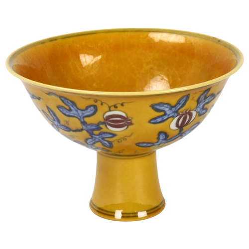 292 - A yellow Chinese stem bowl with blue under-glaze decoration, character marks inside base, height 10.... 