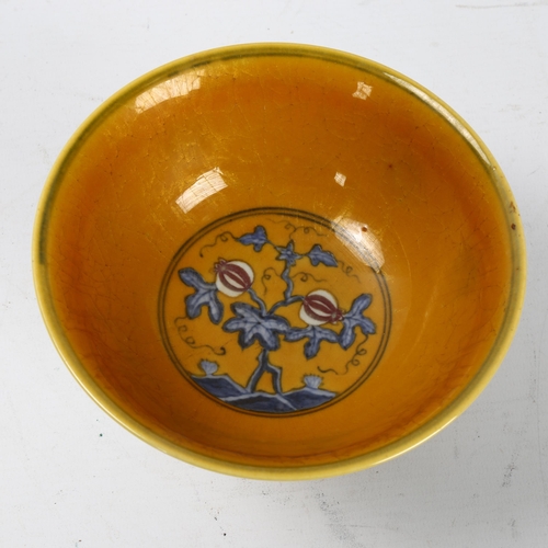 292 - A yellow Chinese stem bowl with blue under-glaze decoration, character marks inside base, height 10.... 