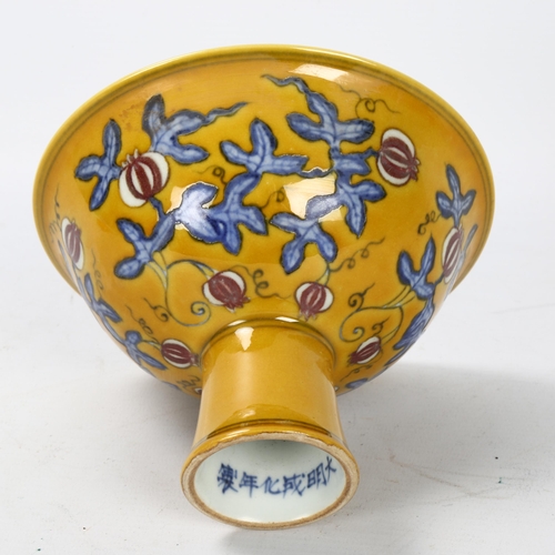 292 - A yellow Chinese stem bowl with blue under-glaze decoration, character marks inside base, height 10.... 