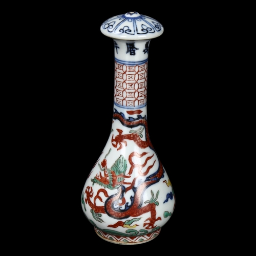 295 - A Chinese porcelain handle with painted sea dragon design, length 14cm