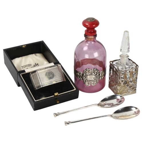 298 - A cased silver napkin ring, a cased pair of silver spoons, and 2 perfume bottles with plated mounts