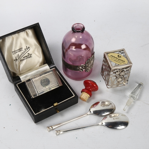 298 - A cased silver napkin ring, a cased pair of silver spoons, and 2 perfume bottles with plated mounts