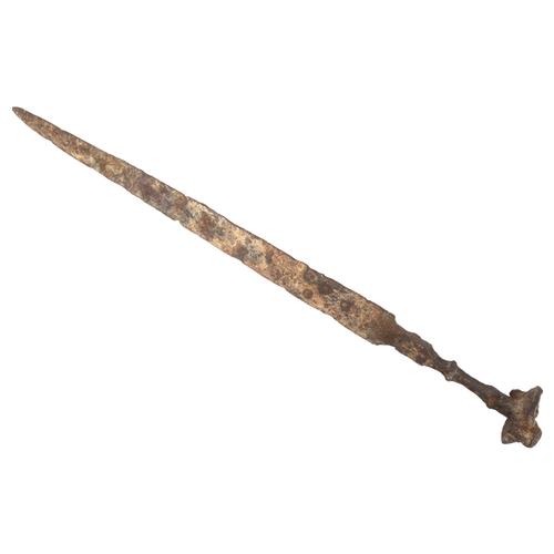 312 - ANTIQUITIES - a rare Iron Age sword with mask decorated pommel, length 68cm