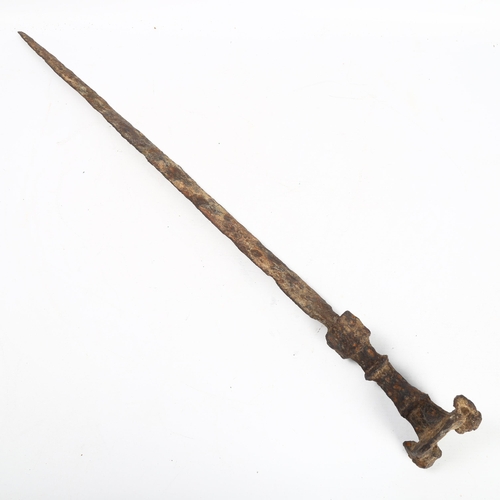 312 - ANTIQUITIES - a rare Iron Age sword with mask decorated pommel, length 68cm