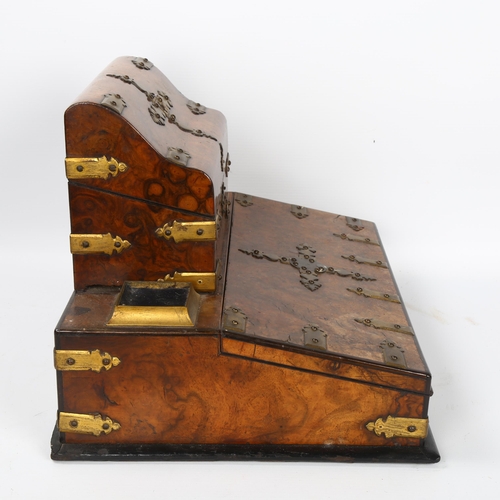 10 - A Victorian burr-walnut desk stand, with hinged stationery compartment above, and gilt-brass strapwo... 