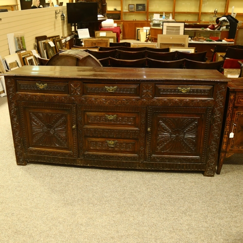 14 - An 18th century oak dresser base, 3 carved frieze drawers with central dummy drawers below flanked b... 