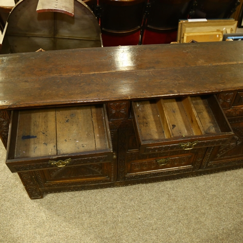 14 - An 18th century oak dresser base, 3 carved frieze drawers with central dummy drawers below flanked b... 