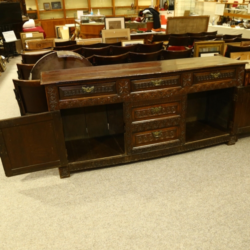 14 - An 18th century oak dresser base, 3 carved frieze drawers with central dummy drawers below flanked b... 