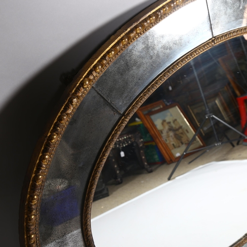 22 - A large oval gilt-framed wall mirror, with inset oxidised mirrored surround, overall measurements 13... 