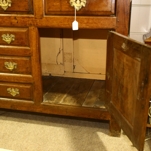 28 - An 18th century oak Welsh dresser, with boarded open plate rack above, 3 frieze drawers with 3 dummy... 