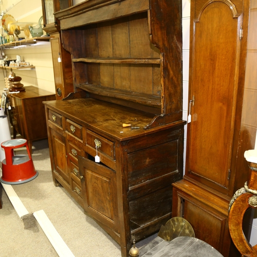 28 - An 18th century oak Welsh dresser, with boarded open plate rack above, 3 frieze drawers with 3 dummy... 