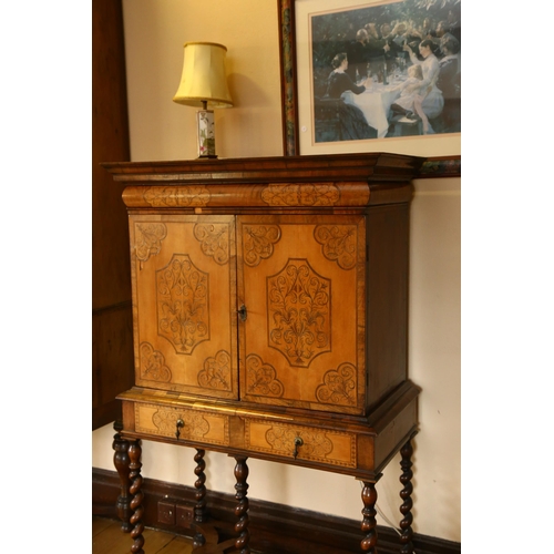 35 - A William and Mary walnut olivewood and kingwood cabinet on stand, circa 1690, the moulded cornice a... 