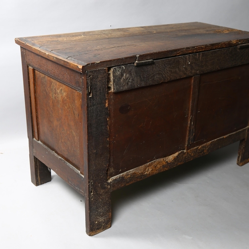 41 - A Charles I oak coffer, with plank lid, the front with 3 panels each carved with a vase of flowers w... 