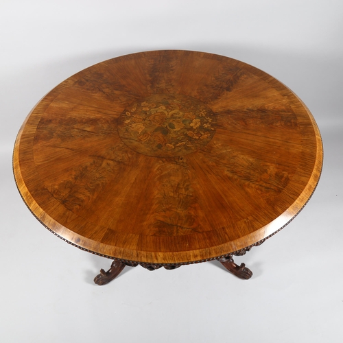 42 - A Regency walnut circular centre table, with central stained floral marquetry inlaid panel, egg and ... 