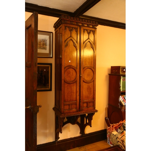 48 - A large 19th century Gothic oak church tabernacle wall-hanging cabinet, the crenellated pediment wit... 