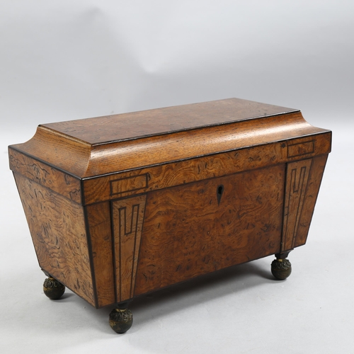 50 - A Regency burr-walnut sarcophagus tea caddy, with ebonised moulding and brass bun feet, width 35cm, ... 
