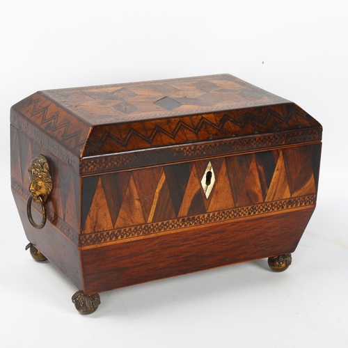 52 - A Regency marquetry inlaid tumbling cube tea caddy, with brass figural ring handles and bun feet, wi... 