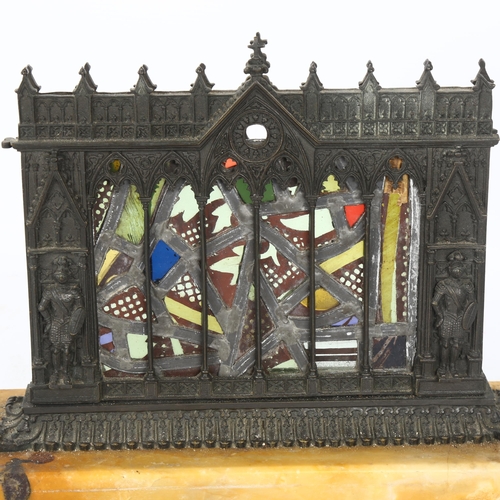 55 - A Gothic Revival patinated bronze stained glass table centre piece, depicting knights standing benea... 