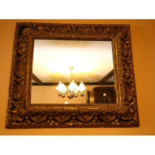 62 - A large gilt-gesso foliate rectangular wall mirror, overall 85cm x 98cm