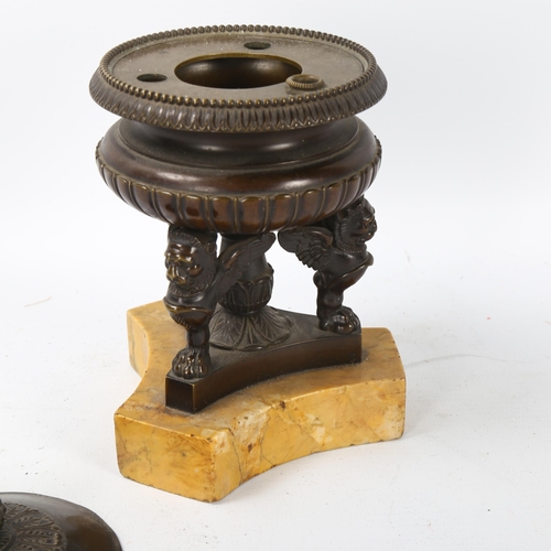 71 - A 19th century patinated bronze urn-shaped ink stand and cover, supported by winged lion figures on ... 