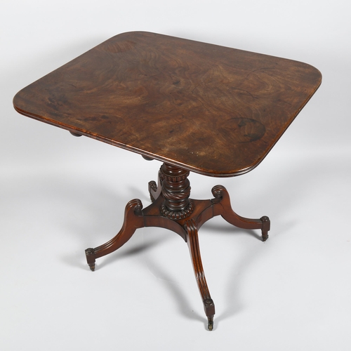 8 - A Regency square mahogany tilt-top table, on carved quadruple base with brass casters, 74cm x 63cm