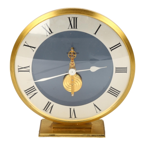 121 - JAEGER LECOULTRE - a brass-cased mantel clock, dome glass front with visible mechanism and perspex s... 