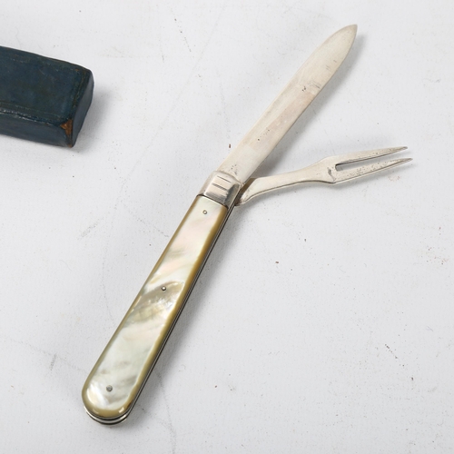 144 - An Edwardian folding fruit knife and fork, hallmarked Sheffield 1907, maker WN, mother of pearl hand... 