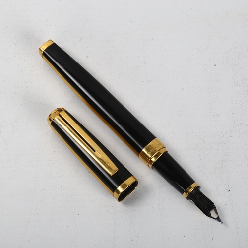 152 - A Waterman Exception Night and Day square section fountain pen, in black and gold metal, with 18k go... 