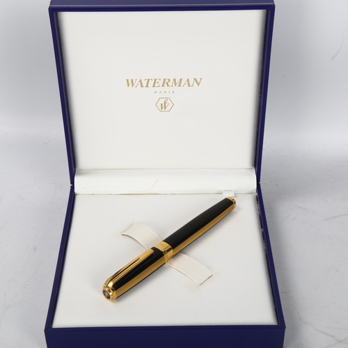 152 - A Waterman Exception Night and Day square section fountain pen, in black and gold metal, with 18k go... 