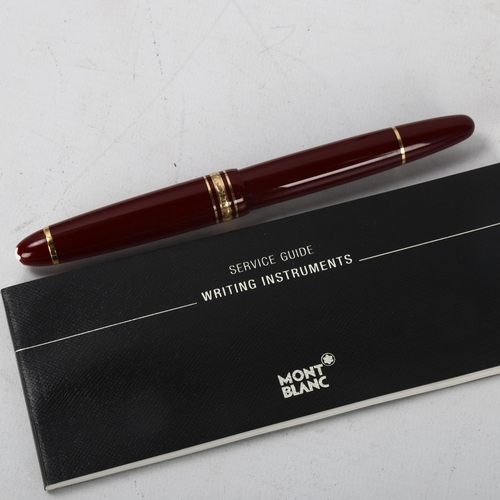 154 - A Mont Blanc Meisterstuck ballpoint pen with burgundy and gold metal body, box and service guide