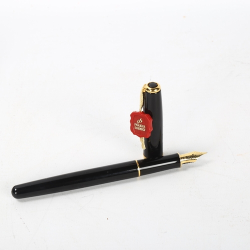 158 - A Parker Sonnet fountain pen, black body with gold metal trim, 18k nib, boxed with papers