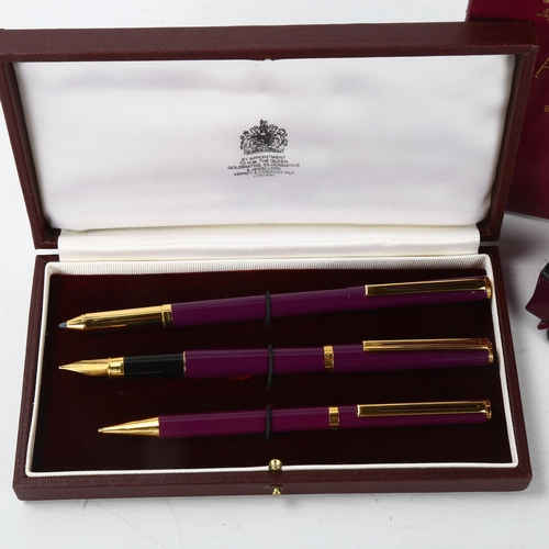 162 - An Asprey, London trio pen set, fountain pen, rollerball and ballpoint pens, purple and gold metal t... 