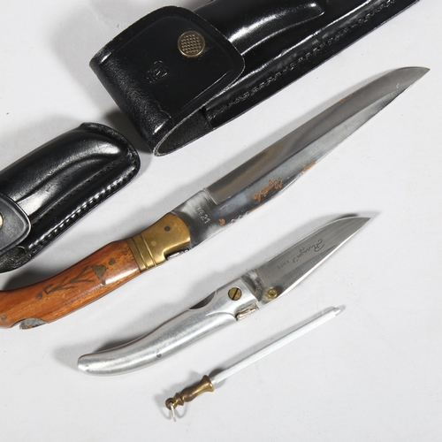 173 - **WITHDRAWN** A Laguiole folding knife, and a smaller pocket knife, leather scabbards (2)