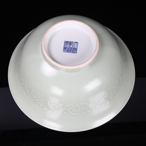 182 - A Chinese celadon porcelain bowl, relief moulded frieze and seal mark, diameter 22cm