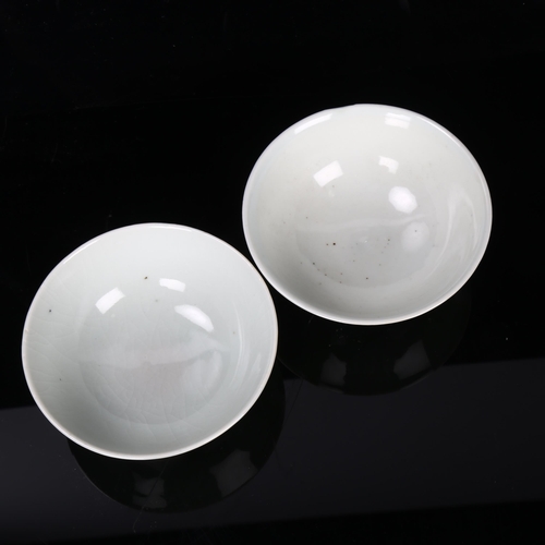 186 - A pair of Chinese celadon porcelain bowls, with relief bat designs, diameter 10cm