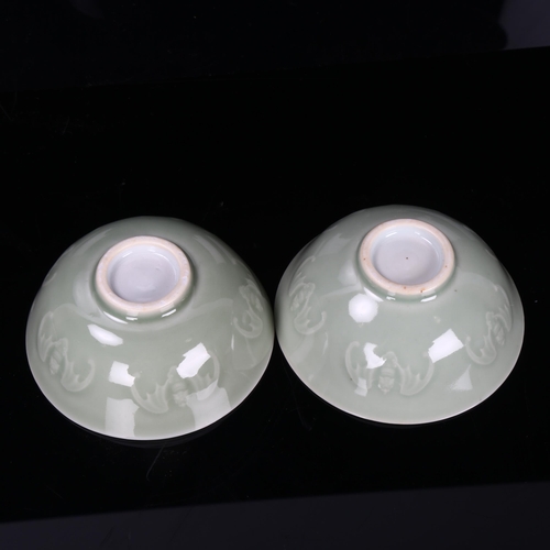 186 - A pair of Chinese celadon porcelain bowls, with relief bat designs, diameter 10cm