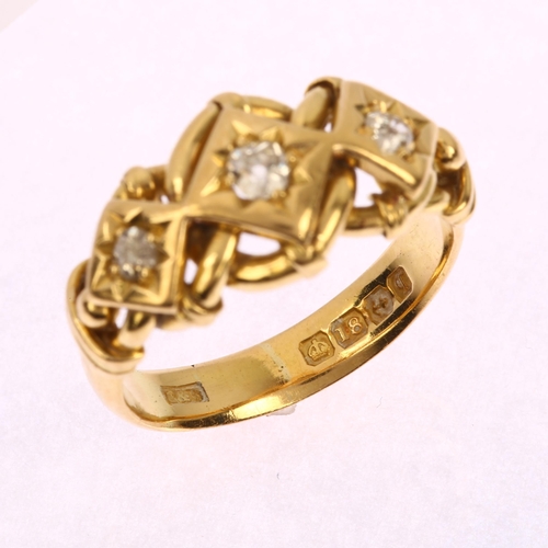 1101 - An early 20th century 18ct gold three-stone diamond ring, star set with old-cut diamonds and curb li... 