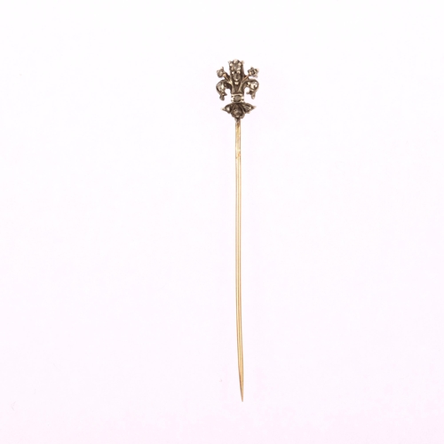 1104 - A 19th century diamond fleur-de-lis stickpin, unmarked gold and silver settings with rose-cut diamon... 