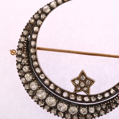 1111 - A large Victorian diamond star and crescent moon brooch, circa 1880, the crescent formed of a centra... 