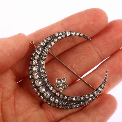 1111 - A large Victorian diamond star and crescent moon brooch, circa 1880, the crescent formed of a centra... 