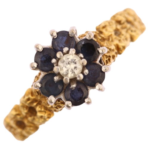 1131 - A late 20th century 18ct gold sapphire and diamond cluster flowerhead ring, with textured shoulders,... 