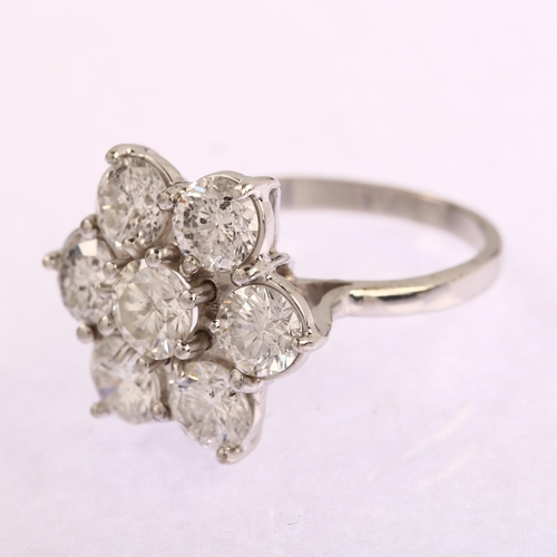 1145 - An 18ct white gold seven stone diamond flowerhead cluster ring, prong set with modern round brillian... 