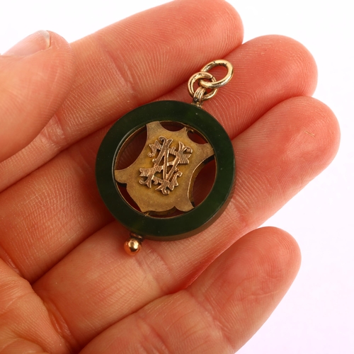 1156 - An early 20th century New Zealand nephrite pendant, circular form with openwork central shield, appl... 