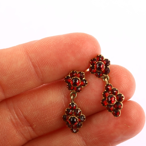 1165 - A pair of late 20th century 9ct gold garnet drop earrings, set with round cabochon and faceted garne... 