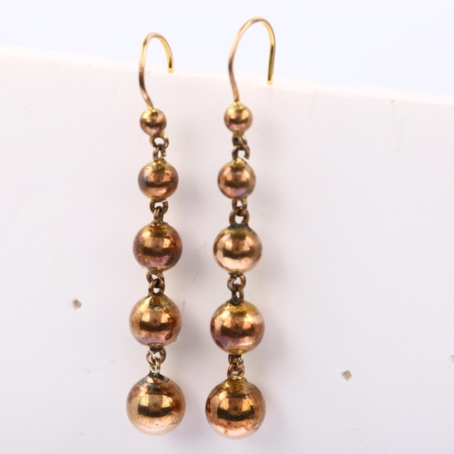 1173 - A pair of graduated ball drop earrings, unmarked yellow metal settings, with shepherd hook fittings,... 