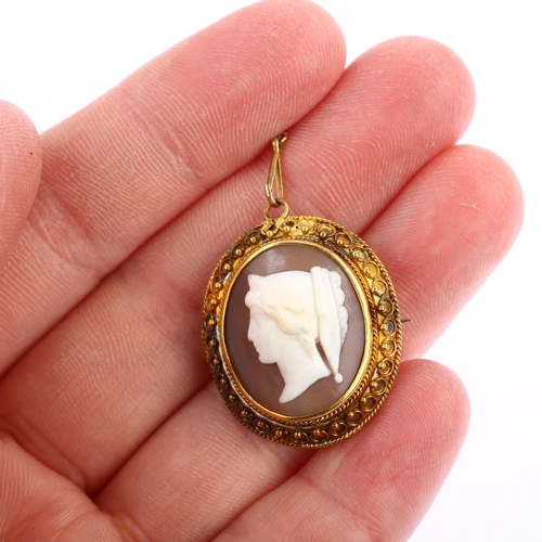 1175 - A Victorian shell cameo brooch, relief carved depicting Classical female profile, in unmarked gold E... 