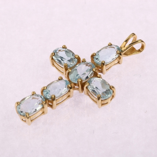 1208 - A modern 9ct gold blue topaz cross pendant, prong set with oval mixed-cut topaz, pendant height 31mm... 